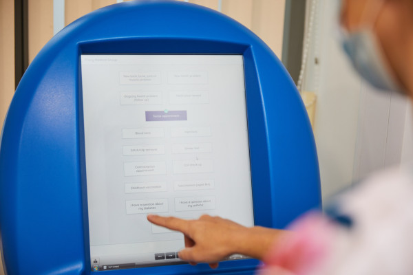 A photo showing a patient using the prioryCARE form