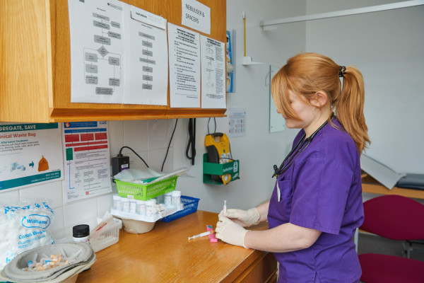 A phot showing Dr Callaghan with blood taking equipment