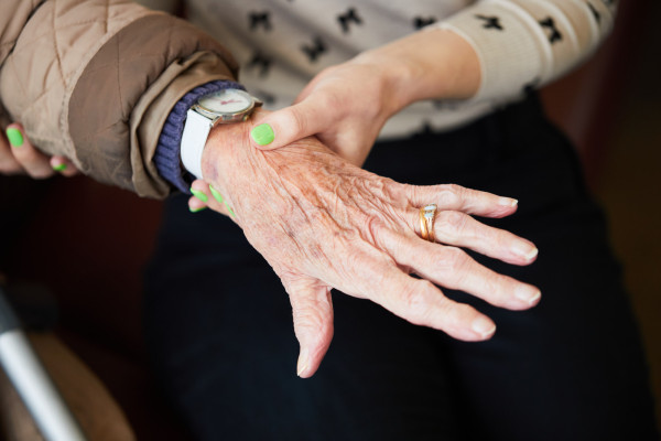 A photo showing a patient having their pulse checked