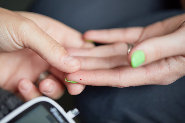 A photo showing a patient having their blood pressure checked